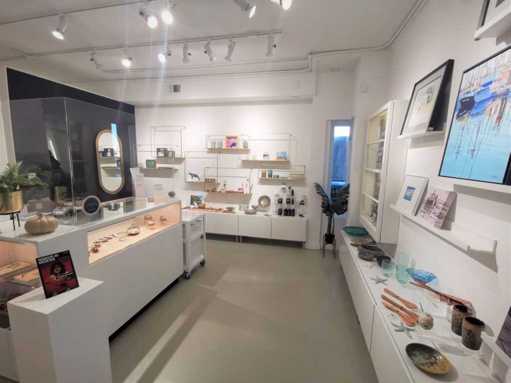 Photograph of the inside of the Art Gallery Shop displaying Artisan Products for sale on shelves.
