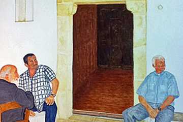 Men sitting in front of a golden doorway